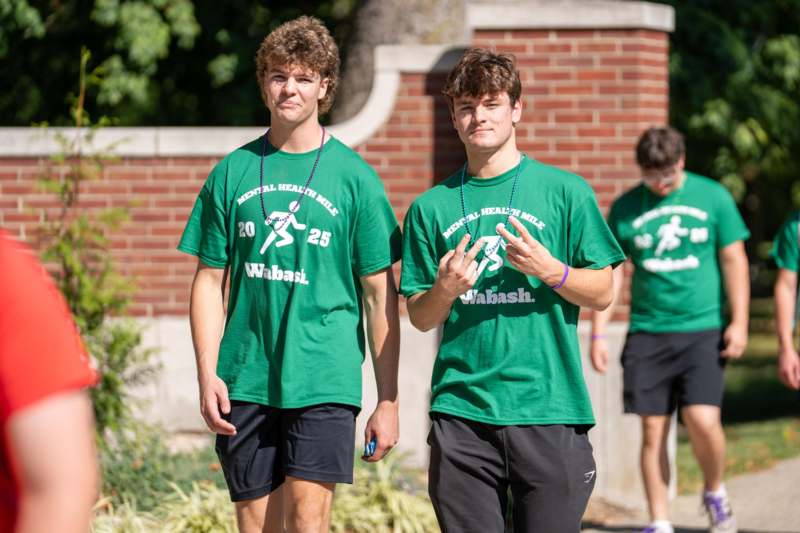 a group of men wearing green shirts