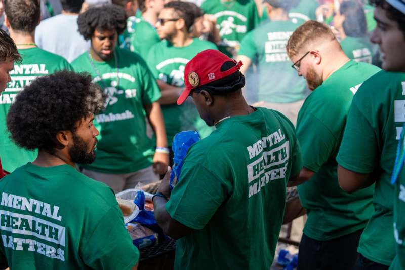 a group of people in green shirts