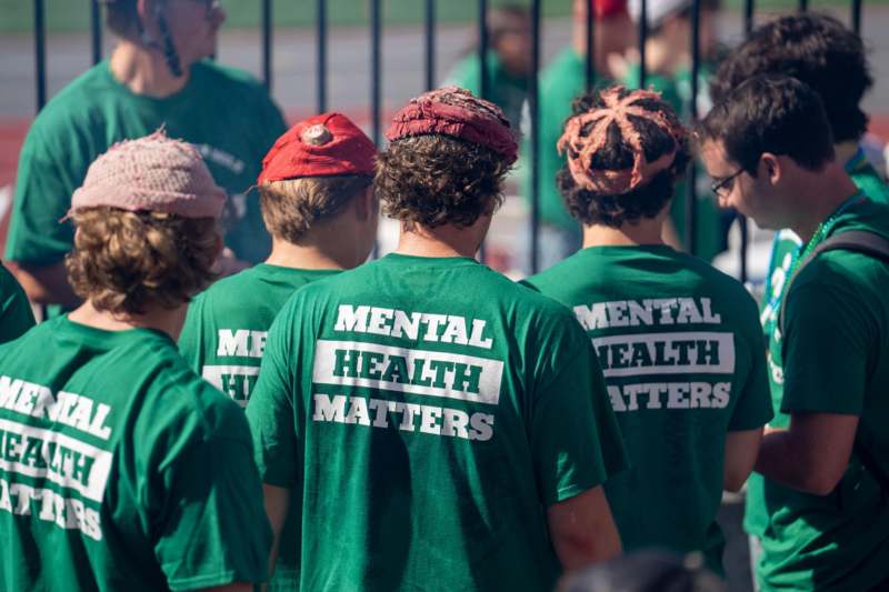 a group of people wearing green shirts