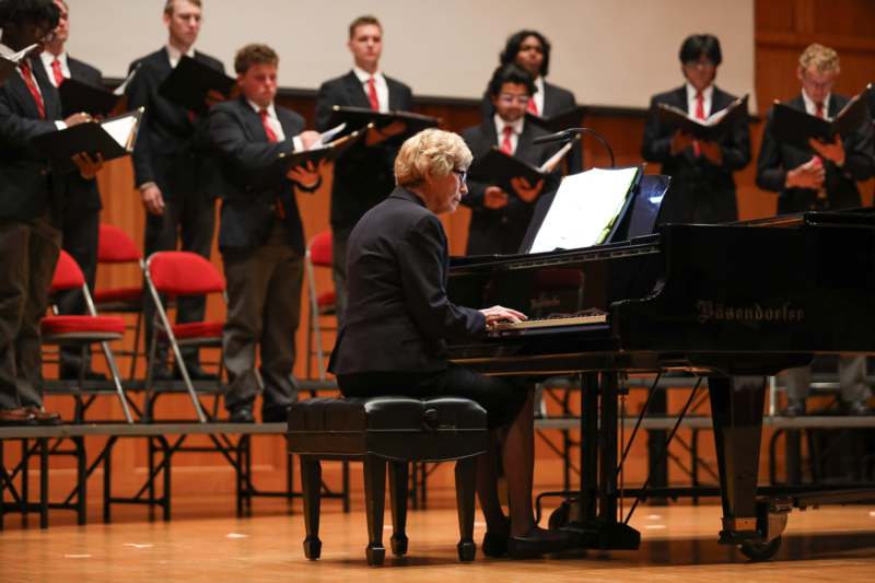 a woman playing a piano