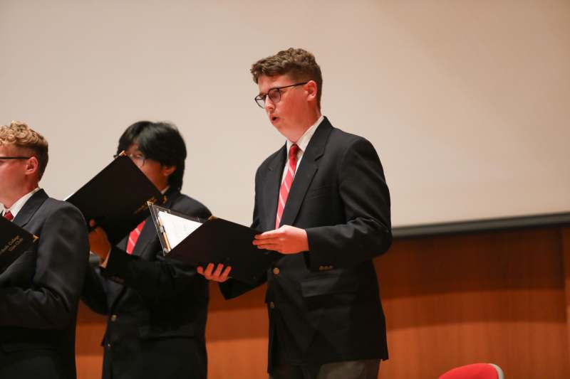 a man in a suit holding a folder