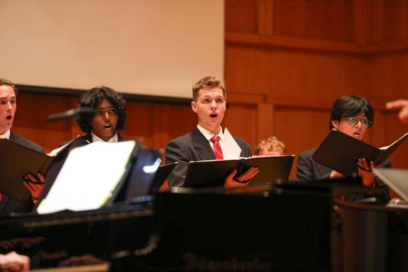 a group of people singing in a choir