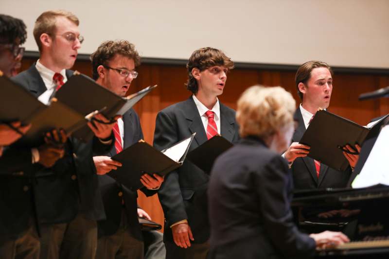a group of people singing in a choir