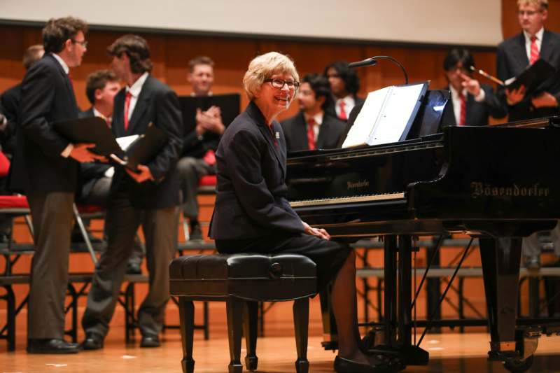 a woman sitting at a piano