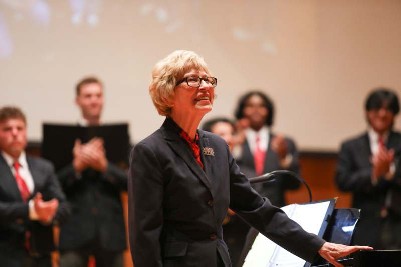 a woman standing at a podium