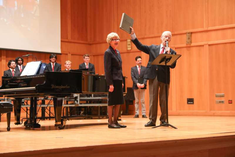 a man holding a microphone and a woman holding a microphone