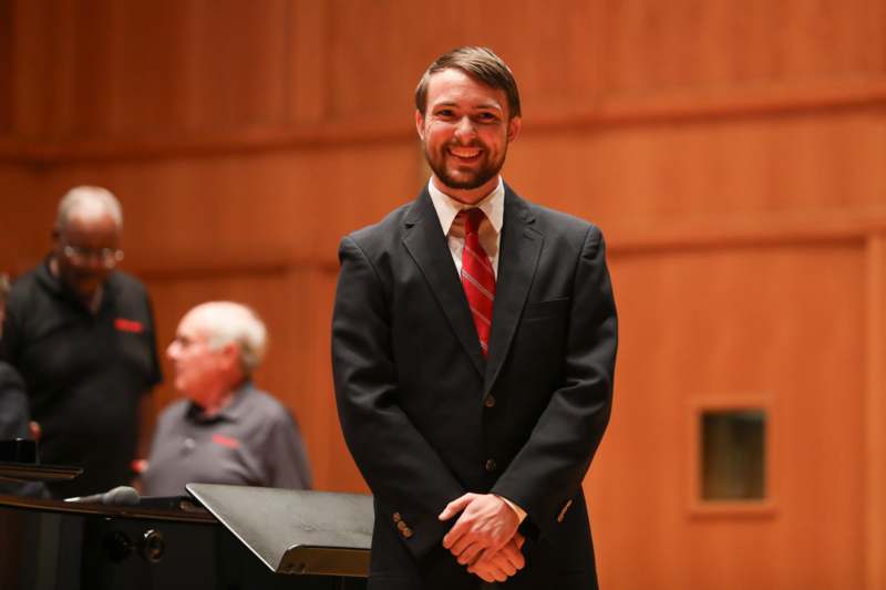 a man in a suit smiling