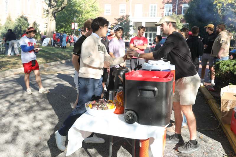 TGIF Fall Fest - a group of people standing around a table with food