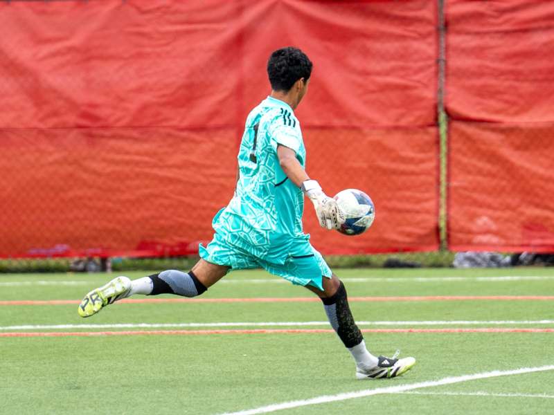 Soccer vs Depauw (10/07/25) - a man in a blue shirt and white gloves holding a football ball