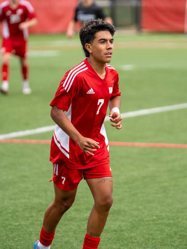 a man in a red uniform on a field