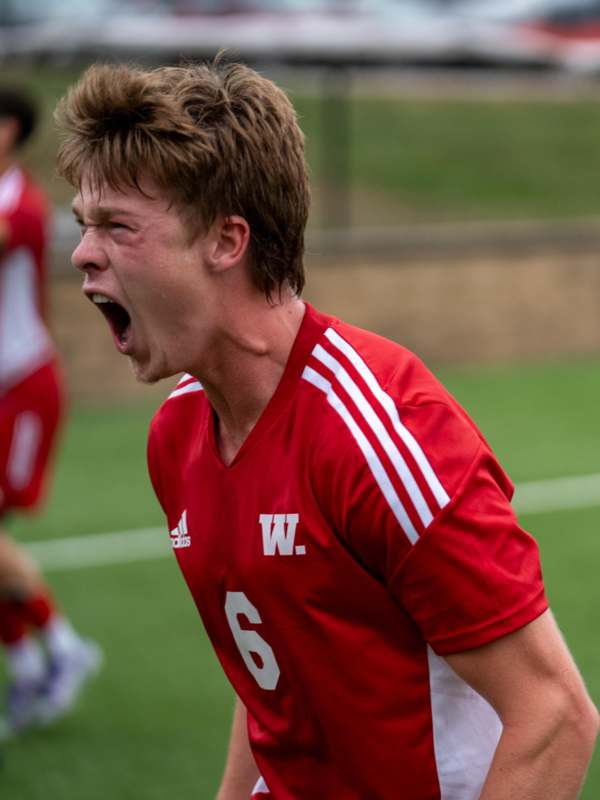 a man in a red shirt screaming