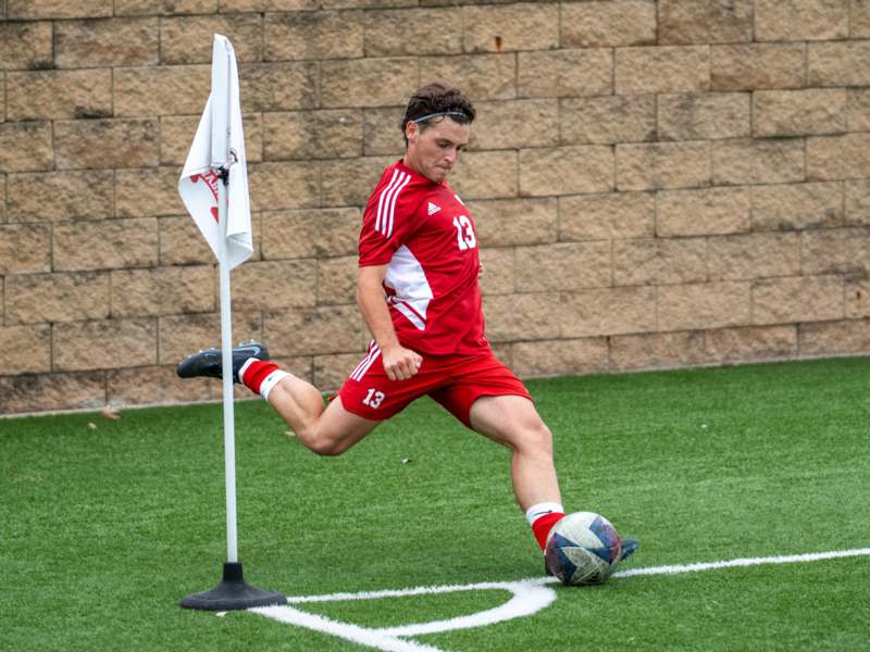 a man kicking a football ball