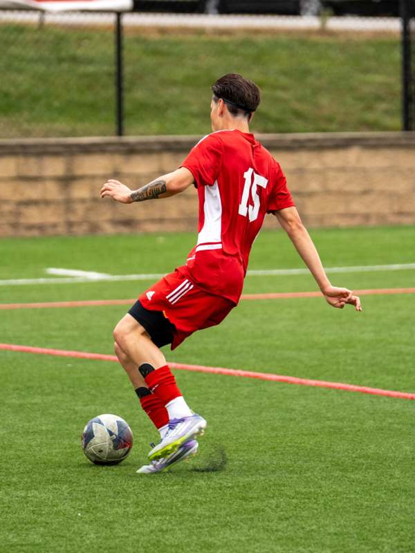 a man kicking a football ball