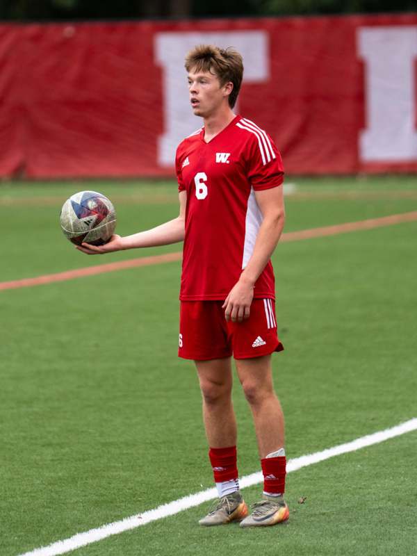 a man holding a football ball