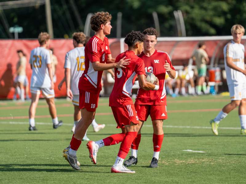 a group of men in red uniforms on a field