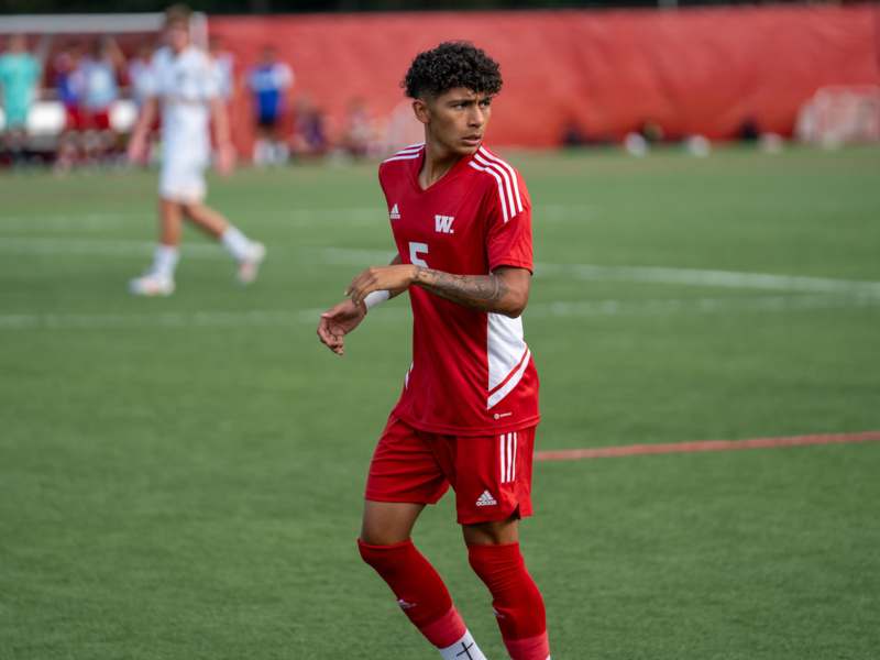 a man in a red uniform on a field