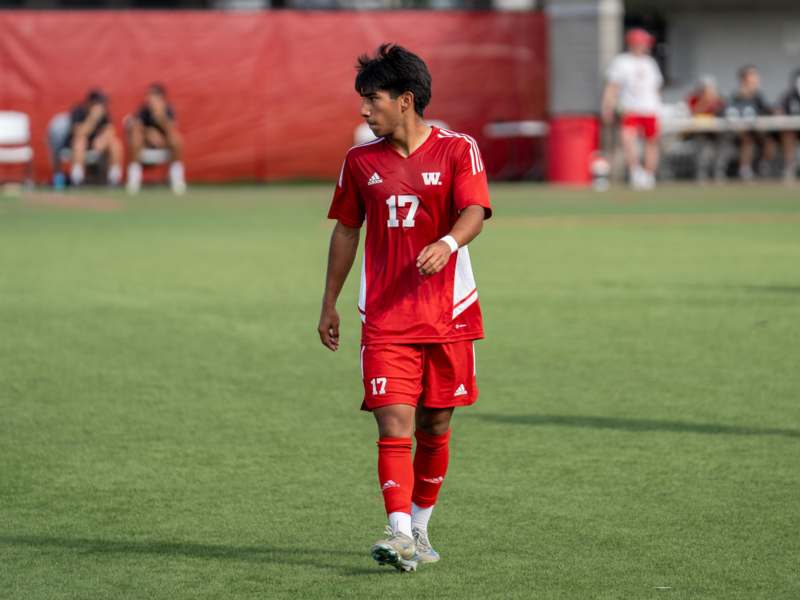 a man in a red uniform on a field