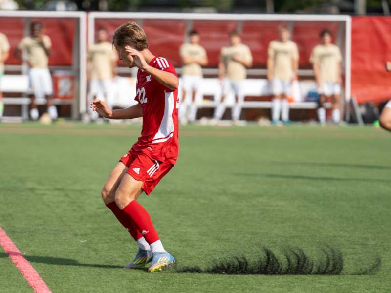 a man in a red uniform running on a field