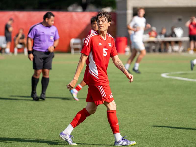 a man in a red uniform on a field