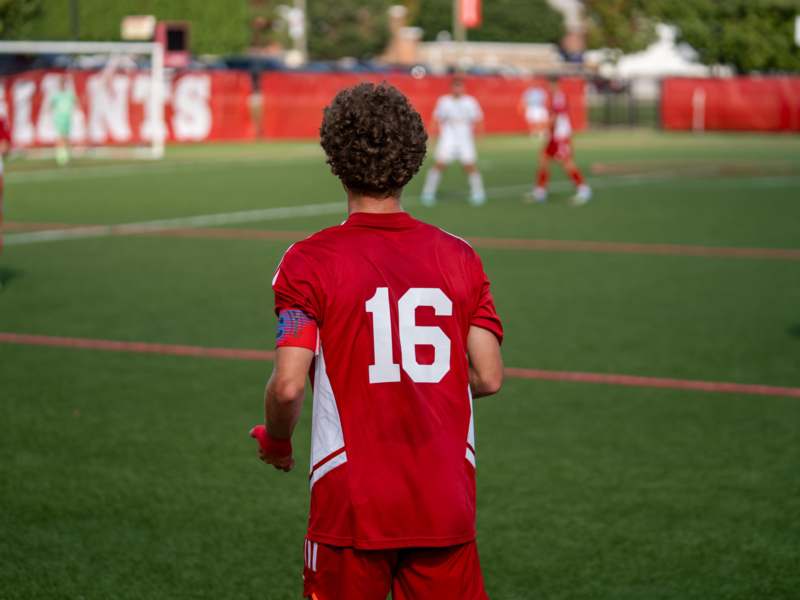 a man in a red uniform on a field