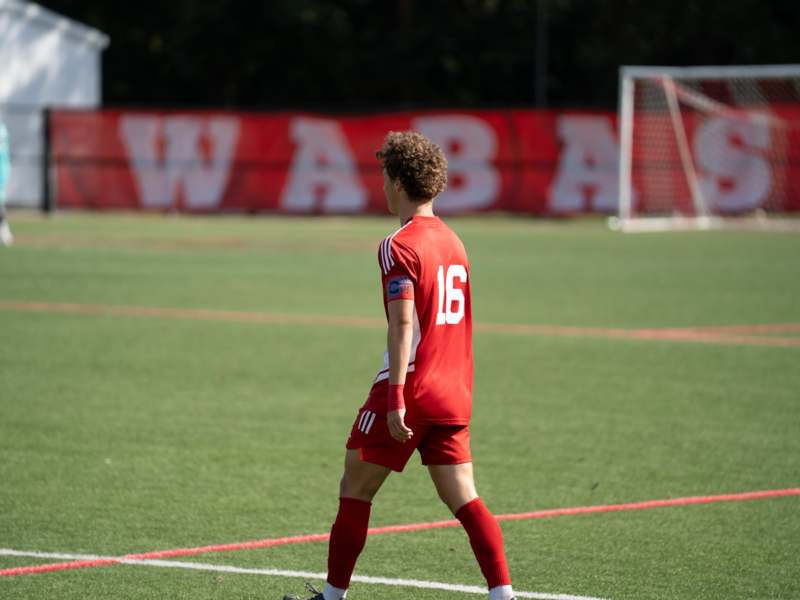 a man in a red uniform on a field