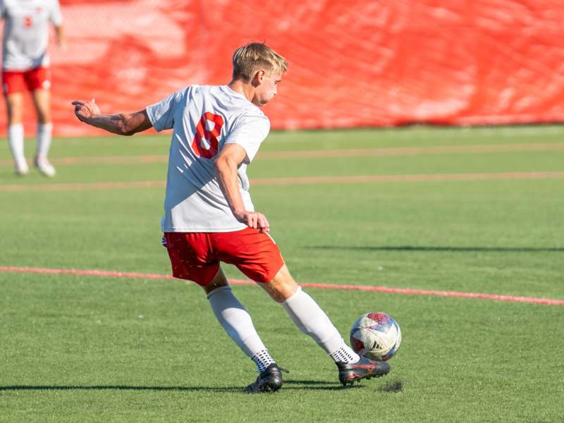 a man kicking a football ball