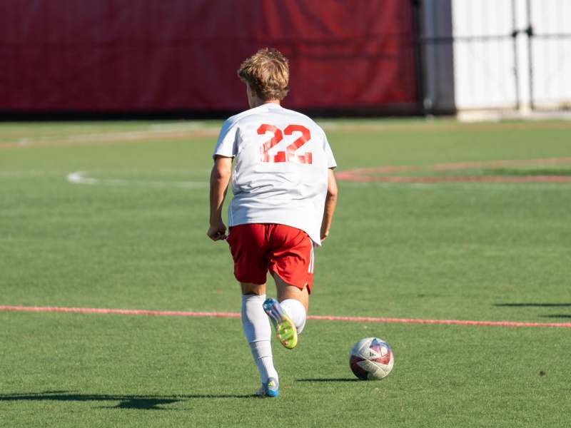 a person running on a field with a football ball