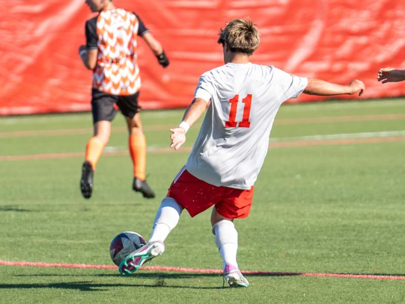 a man kicking a football ball