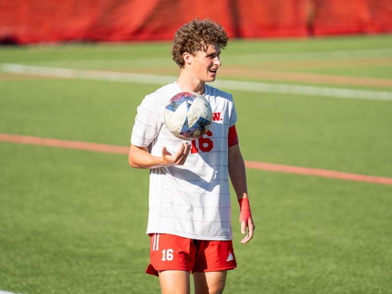 a man holding a football ball