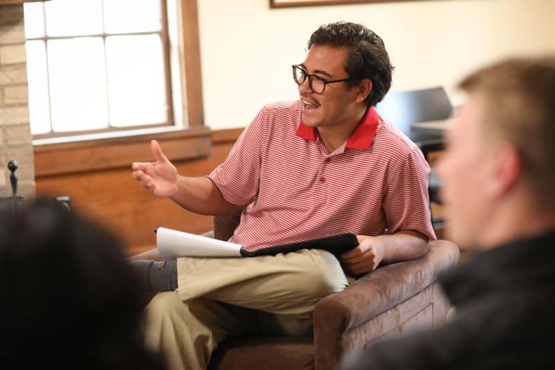 a man sitting in a chair with a book in his hand