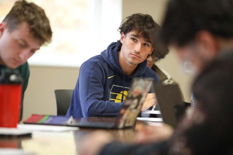 a man sitting at a table with a laptop