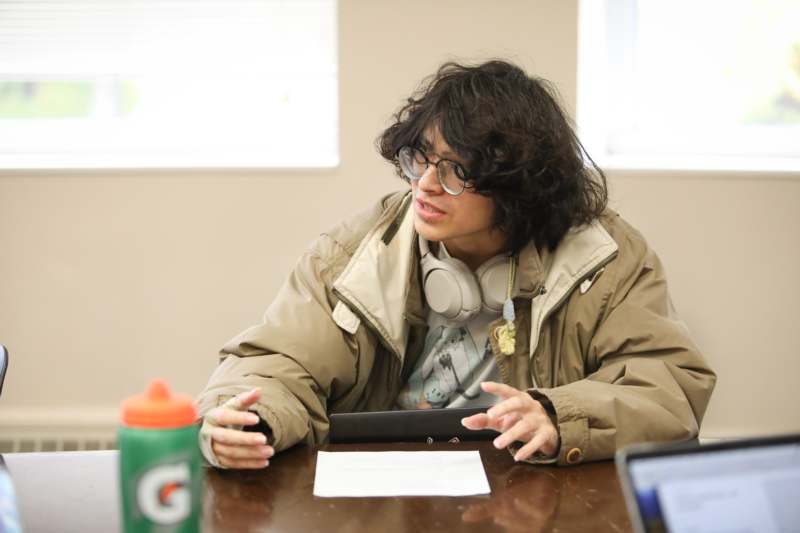 a person sitting at a table with a paper