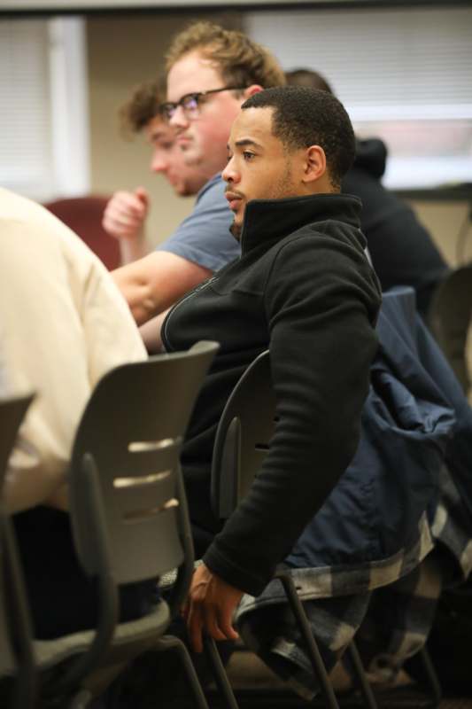 a group of men sitting in chairs