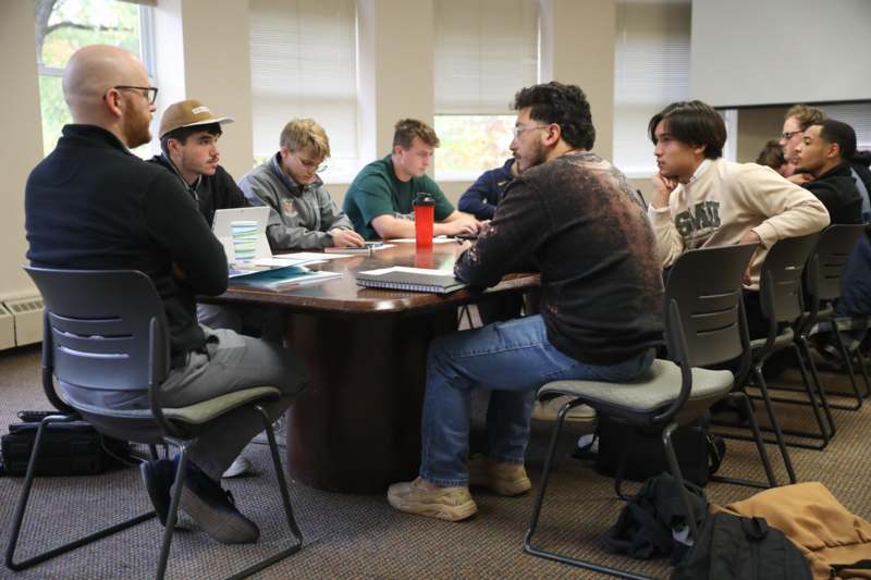 a group of people sitting around a table