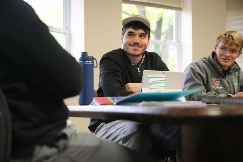 a man sitting at a table with a laptop