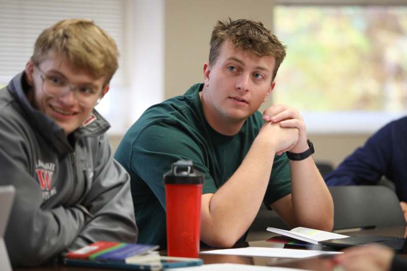 a group of men sitting at a table