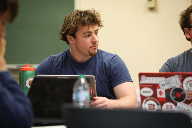 a man sitting at a table with a laptop