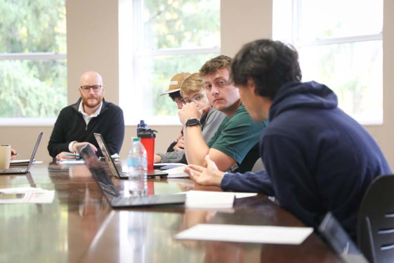 a group of people sitting at a table