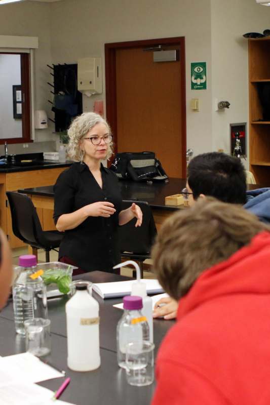 a woman standing in front of a group of people