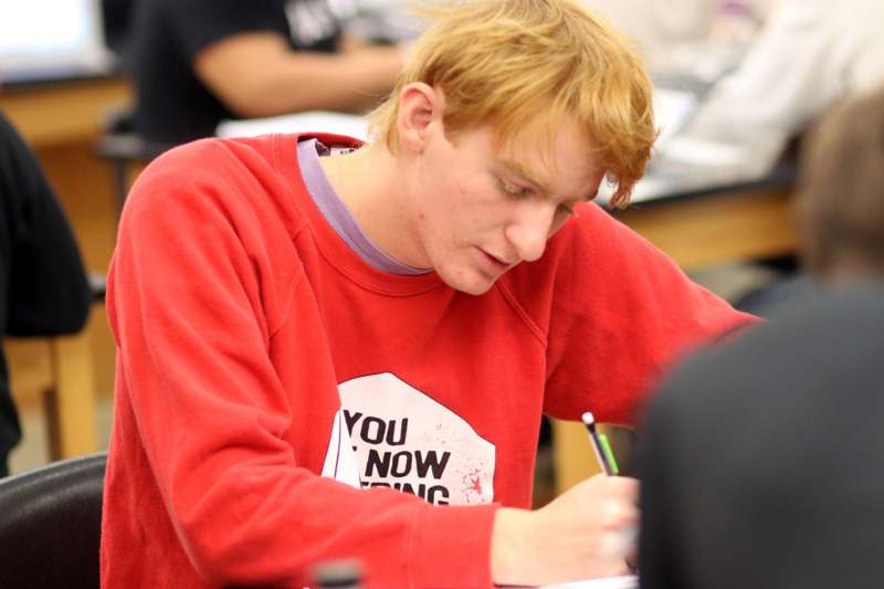 a man writing on a paper