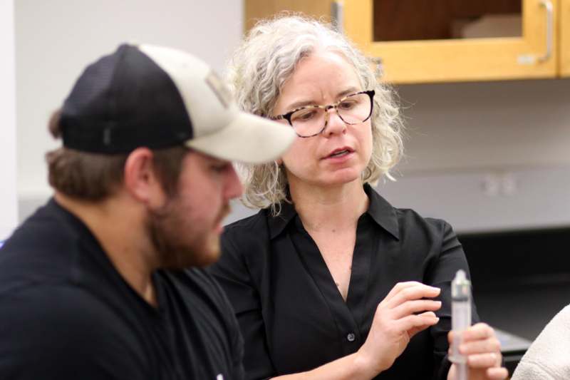 a woman holding a needle