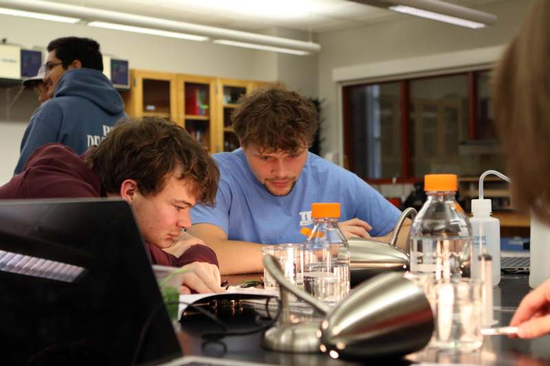a group of men sitting at a table