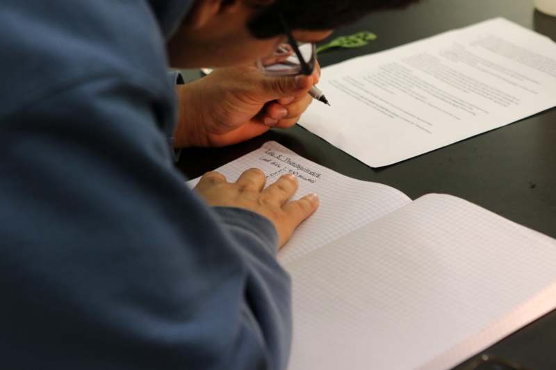 a person writing in a notebook