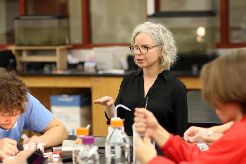 a woman standing in front of a group of people