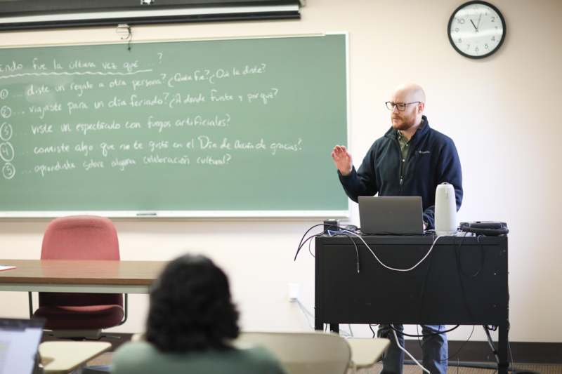 a man standing in front of a chalkboard