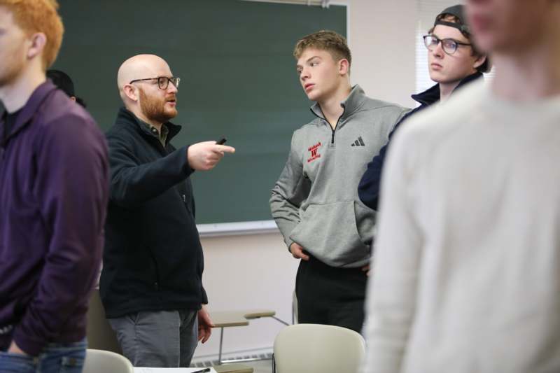a group of people standing in a classroom