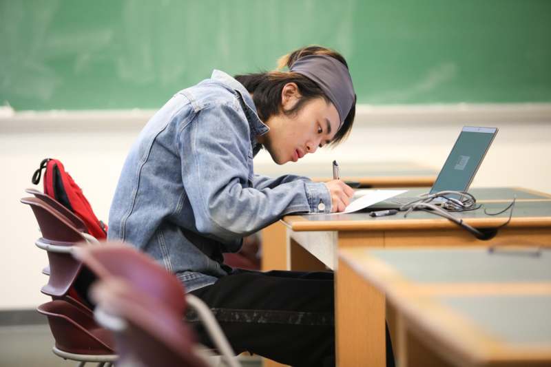 a man writing on a paper