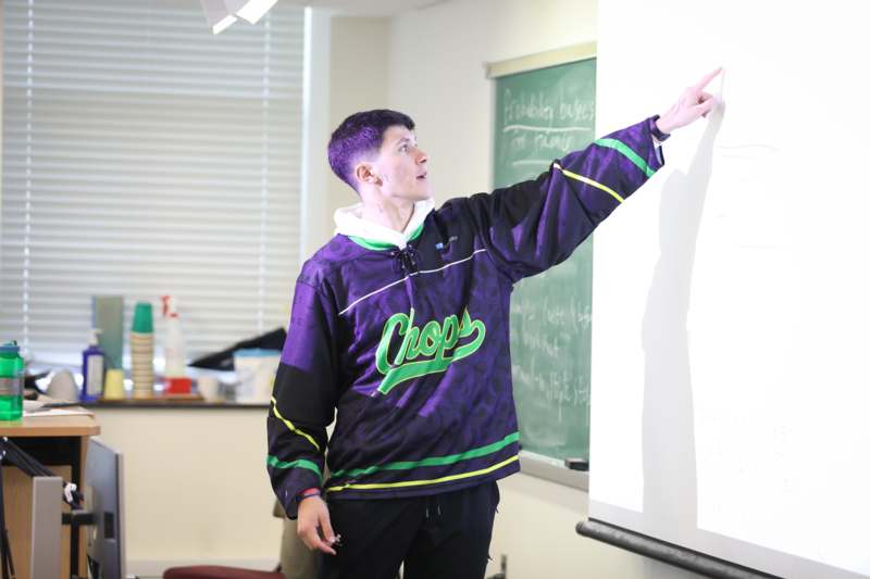 a man pointing at a whiteboard