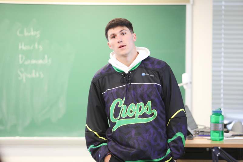 a man standing in front of a chalkboard