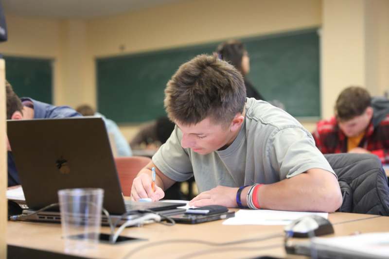 a man writing on a paper